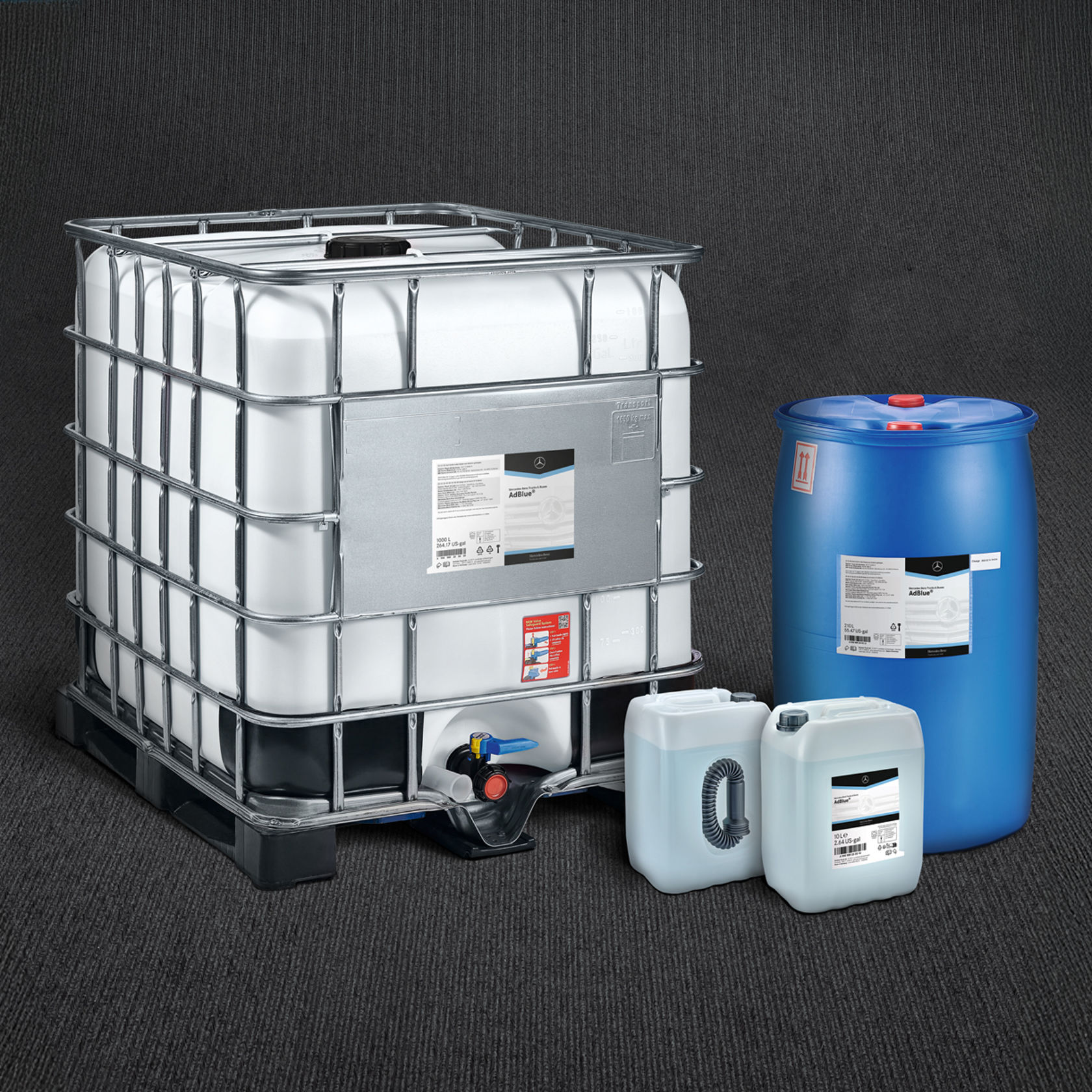 Various containers of operating fluids, including an IBC container, a blue drum and smaller canisters, with Mercedes-Benz logo on a white background.