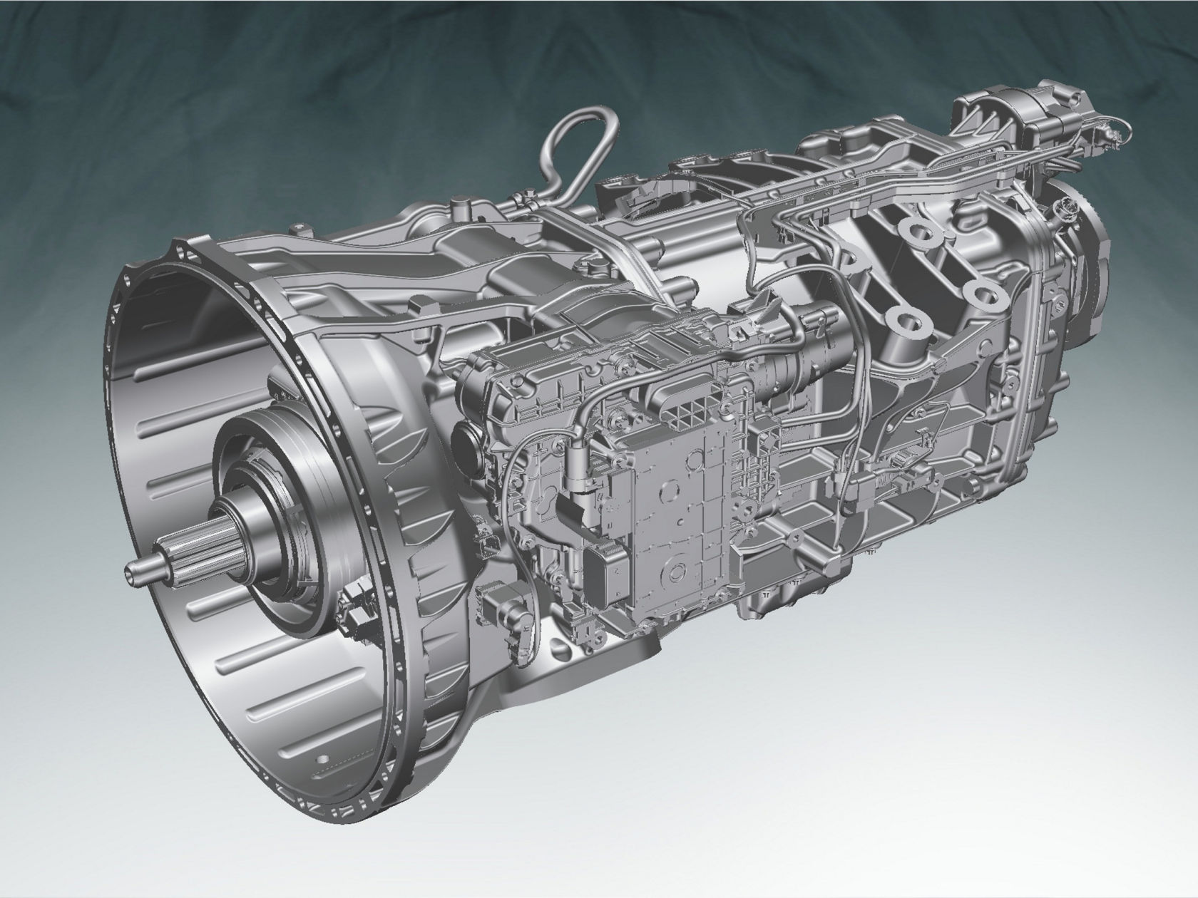 The image shows a detailed 3D model of a complex mechanical component: a transmission. It is in shades of grey and placed against a dark grey background with a lighter area at the bottom left.
