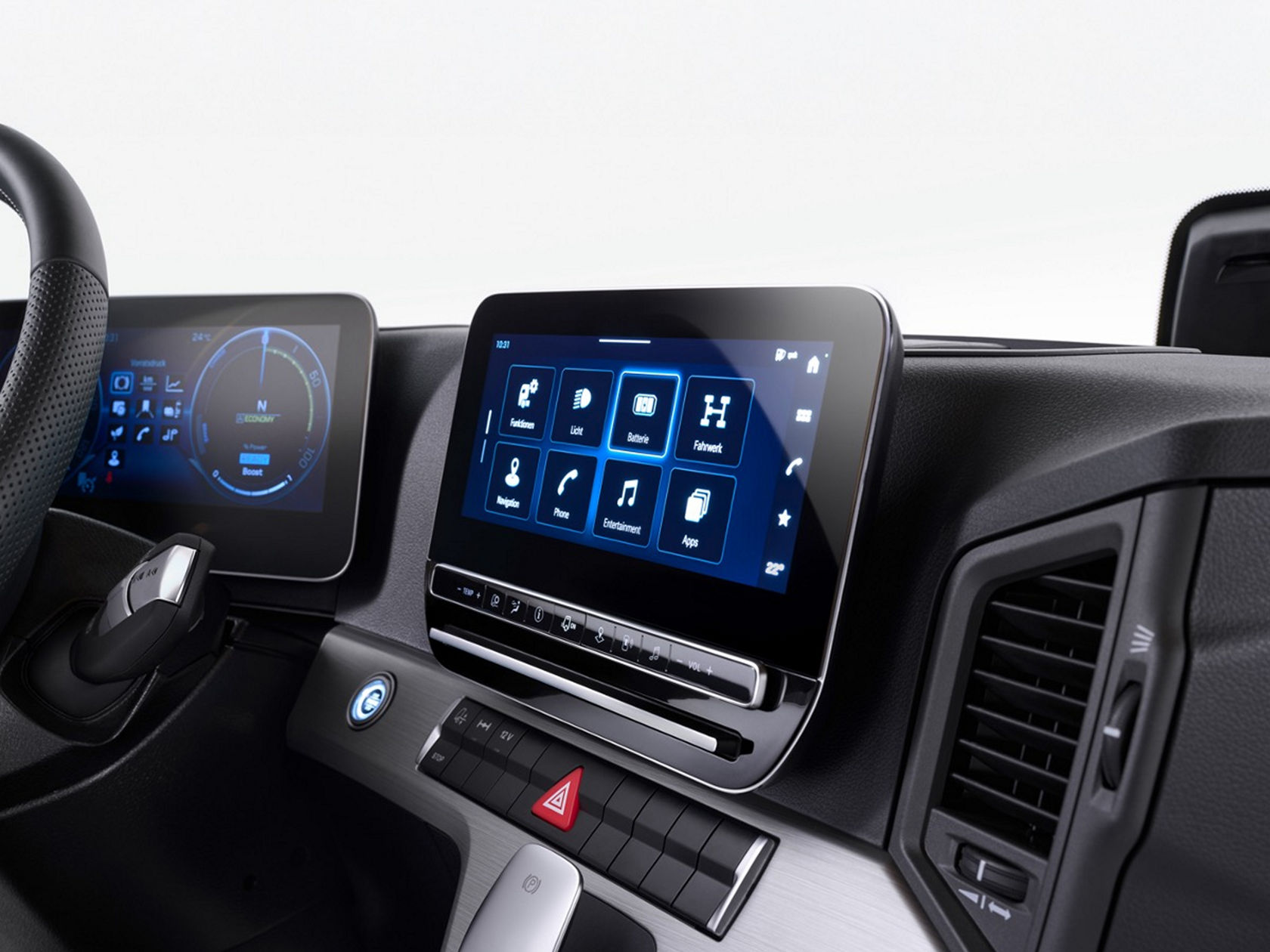 The image shows the interior of a modern truck cab. The focus is on the digital dashboard with two screens, the steering wheel and the controls for functions such as navigation, entertainment and vehicle systems.