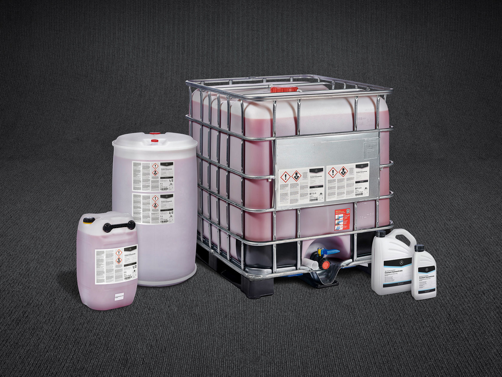 Various containers of antifreeze, including an IBC container, a blue drum and smaller canisters with the Mercedes-Benz logo on a white background