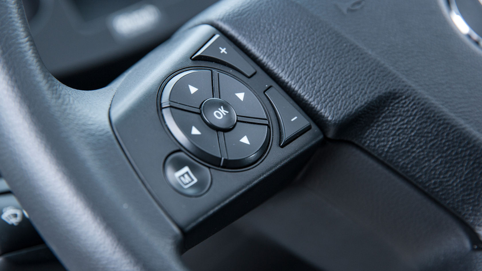 Close-up of the multifunction steering wheel of a Unimog.