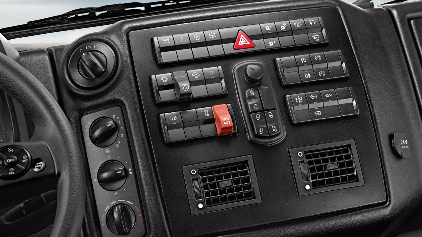 Close-up of the dashboard with various buttons, switches and controls. The dashboard is black and some switches are highlighted in red.